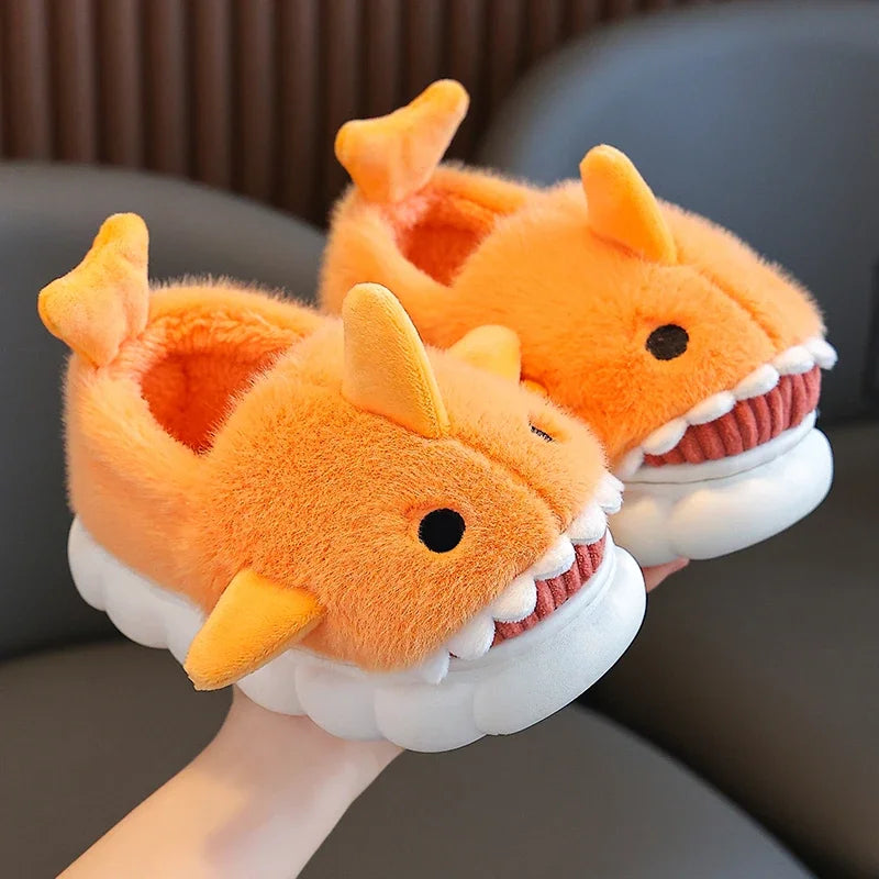 Chaussons pour enfants en forme de requin, couleur orange, avec peluche douce et confortable. Dotés de nageoires latérales et de dents blanches amusantes, ils apportent un style unique et ludique. Parfaits pour garder les pieds au chaud tout en ajoutant une touche de fantaisie.
